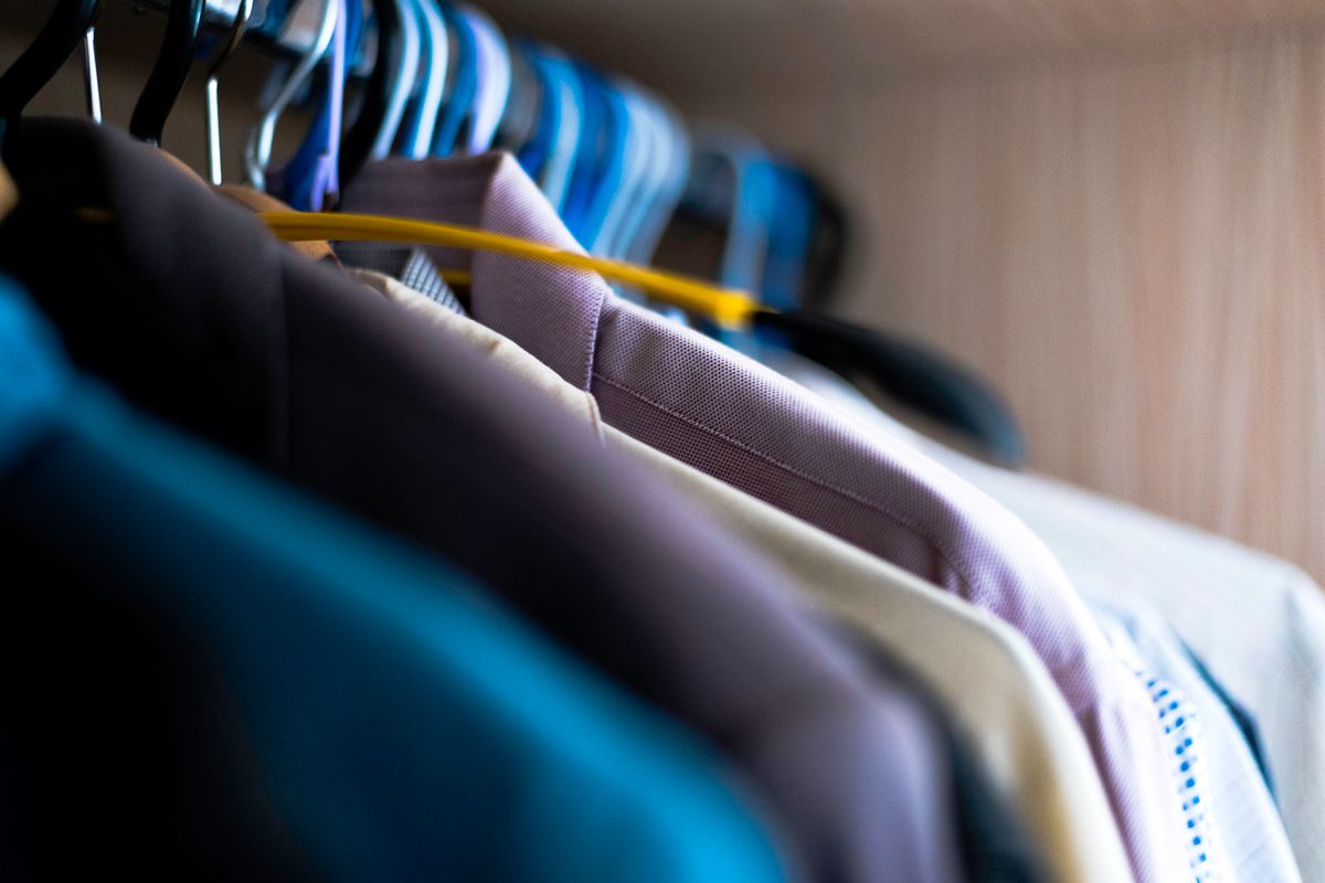 A buttoned shirt laid flat showing the placket and shoulder seams