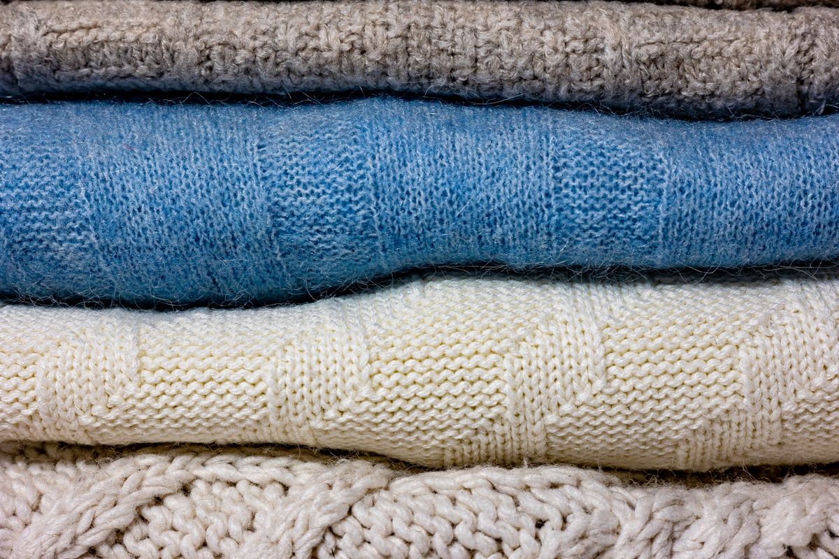 Close-up of folded knitwear showing the texture of the yarn
